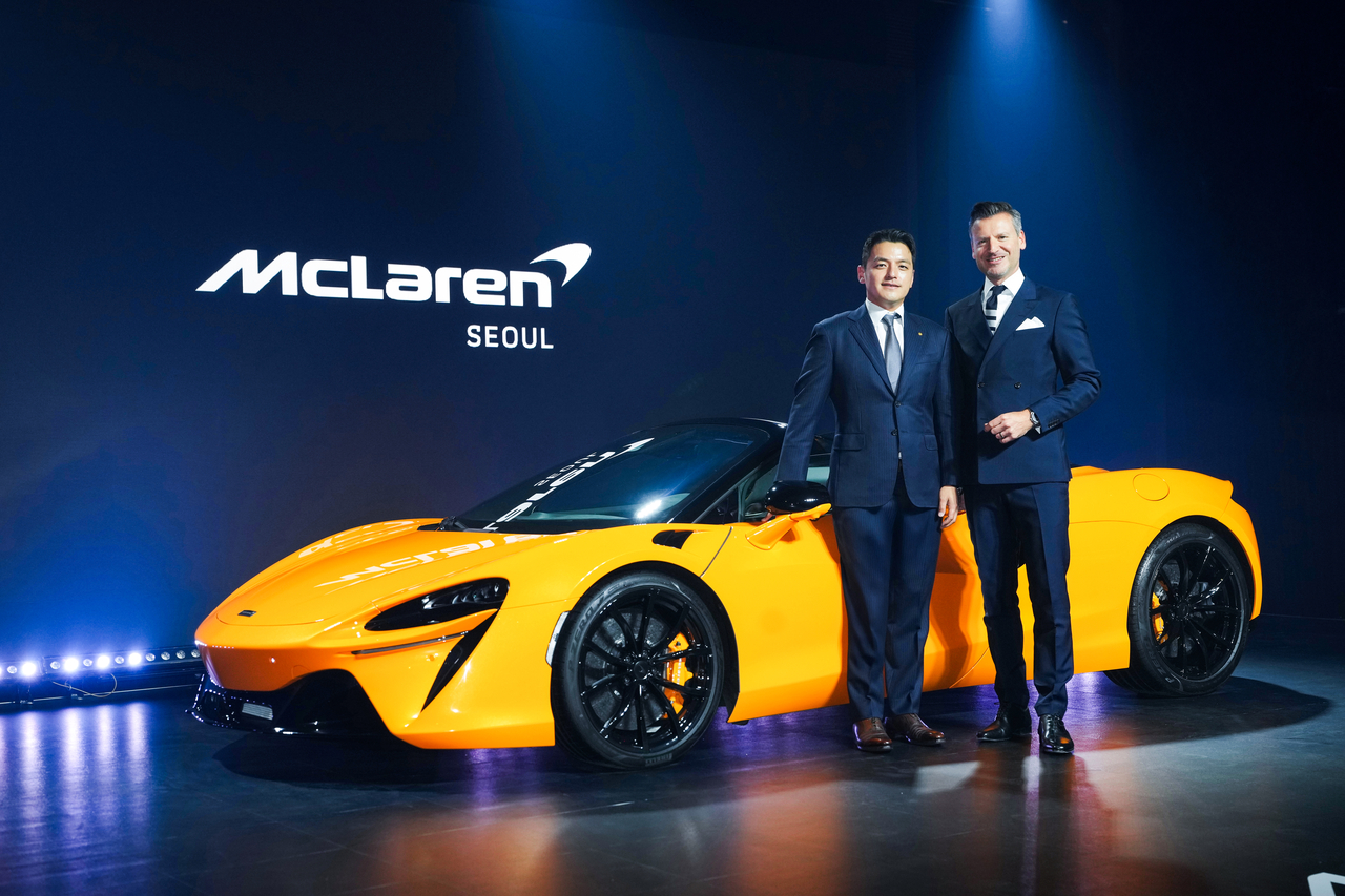 Henrik Wilhelmsmeyer (right), chief commercial officer at McLaren Automotive, and Kwon Hyeok-min, vice chairman of Deutsch Automobile Group and CEO of Britannia Auto, pose for a photo in front of the McLaren Artura Spider launch ceremony at Banyan Tree Club & Spa Seoul on Friday. (Deutsch Automobile Group)
