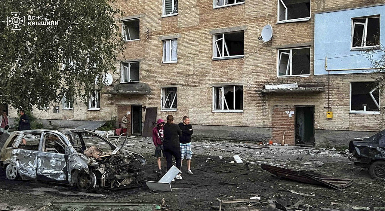 A handout photo provided by the State Emergency Service shows people standing at the site of a shelling following Russian drone attacks in the Kyiv area, Ukraine, on July 6 (EPA-Yonhap)