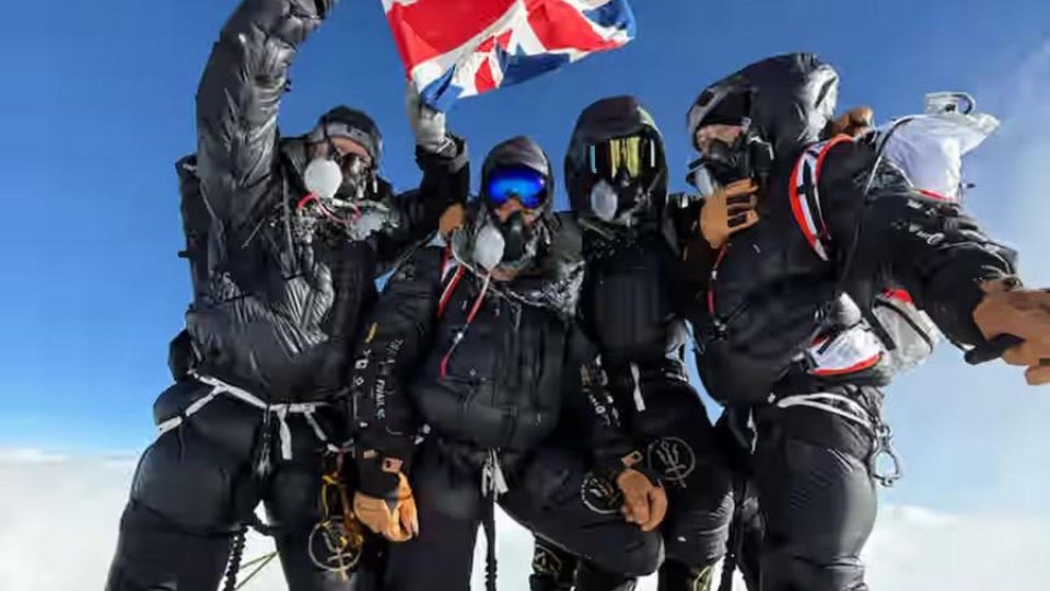 Four British climbers pose on the summit of Mount Everest less than a week after leaving London, in one of the fastest ascents on record of the world's highest peak.    (Kathmandu Post)