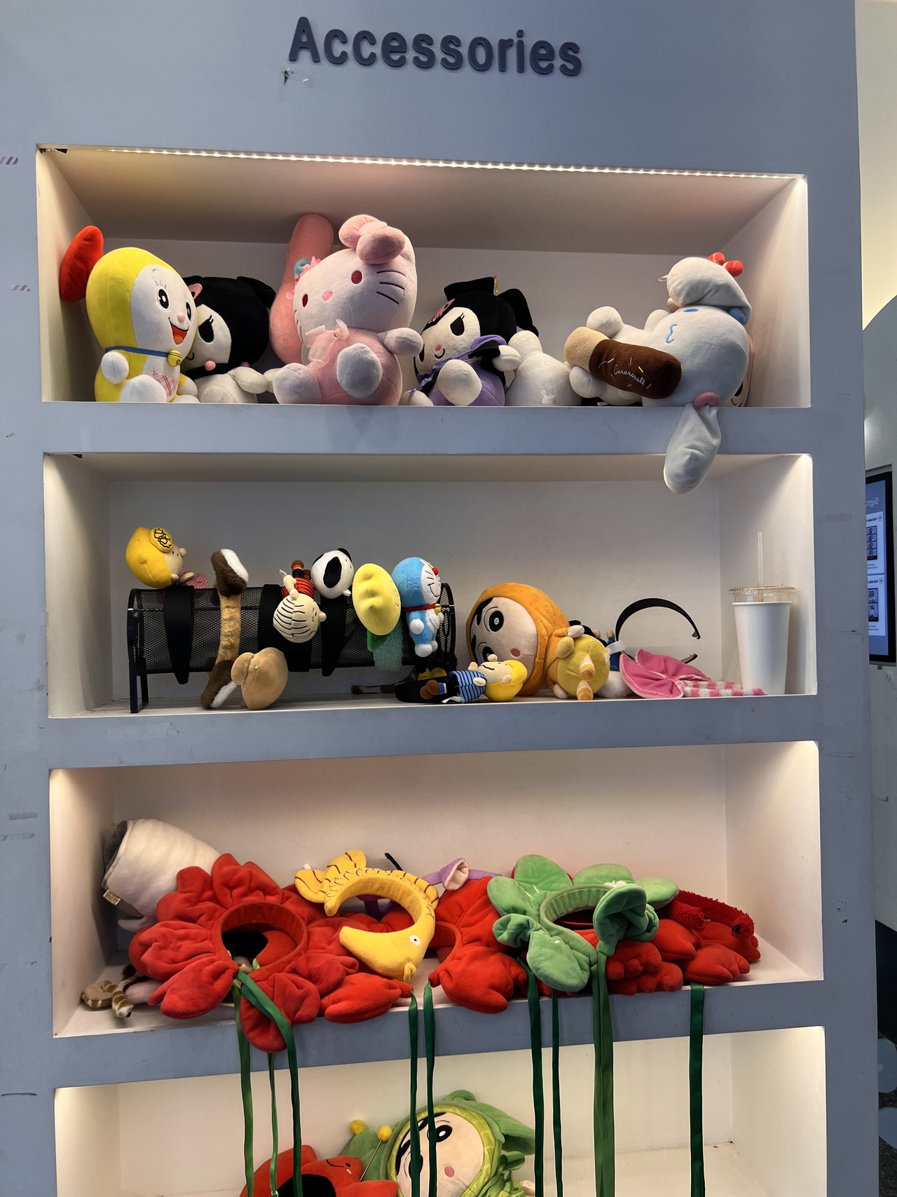Accessories to take photos with fill shelves inside a self-studio photo booth. (Park Jun-hee/The Korea Herald)