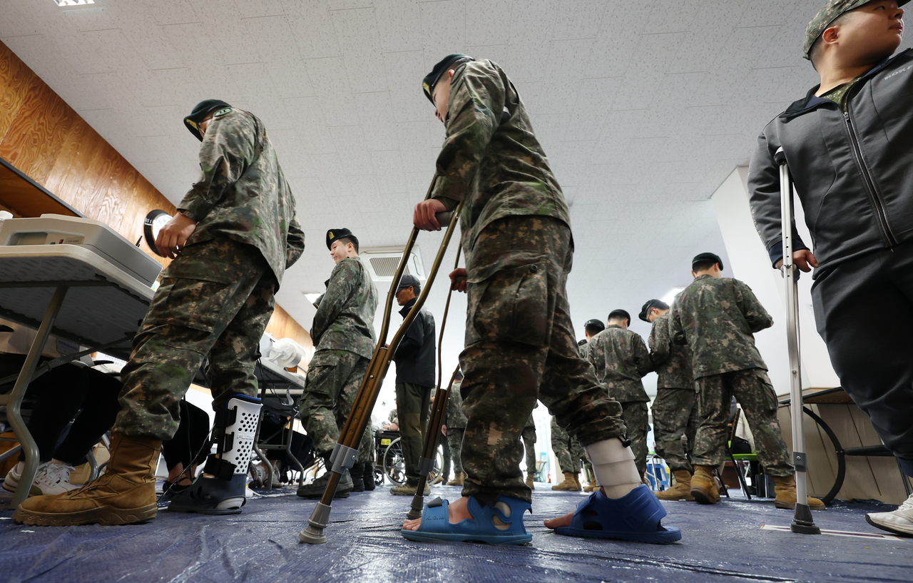 Injured soldiers cast their ballots at an early voting station set up at the Sinbuk-eup Community Center in Chuncheon, Gangwon Province, Thursday. (Yonhap)