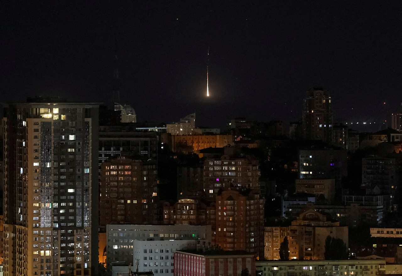 An explosion of a drone is seen in the sky over the city during a Russian drone strike in Kyiv, Ukraine, Sunday. (Reuters-Yonhap)