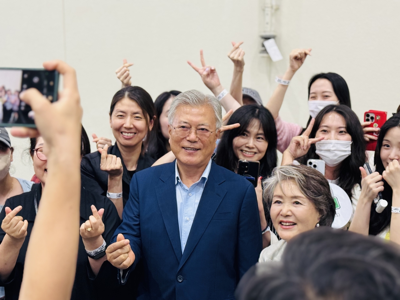 Former President Moon Jae-in poses for a photo with visitors at Seoul International Book Fair 2025 at Coex Convention Center in Seoul on Thursday.. (Sanjay Kumar/ The Korea Herald)