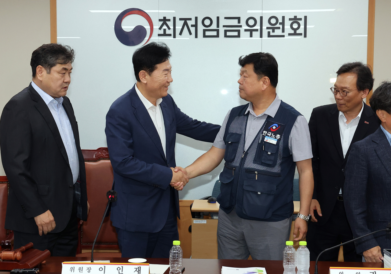 최저신태일 토토사이트위원회 사용자위원 운영위원인 류기정 한국경영자총협회 전무(왼쪽)와 근로자위원 운영위원인 류기섭 한국노총 사무총장이 10일 정부세종청사에서 열린 제12차 전원회의에서 내년 최저신태일 토토사이트을 시간당 1만320원으로 17년 만에 합의로 결정한 뒤 악수하고 있다. 왼쪽은 이인재 위원장, 오른쪽은 이명로 중소기업중앙회 인력정책본부장 [연합]
