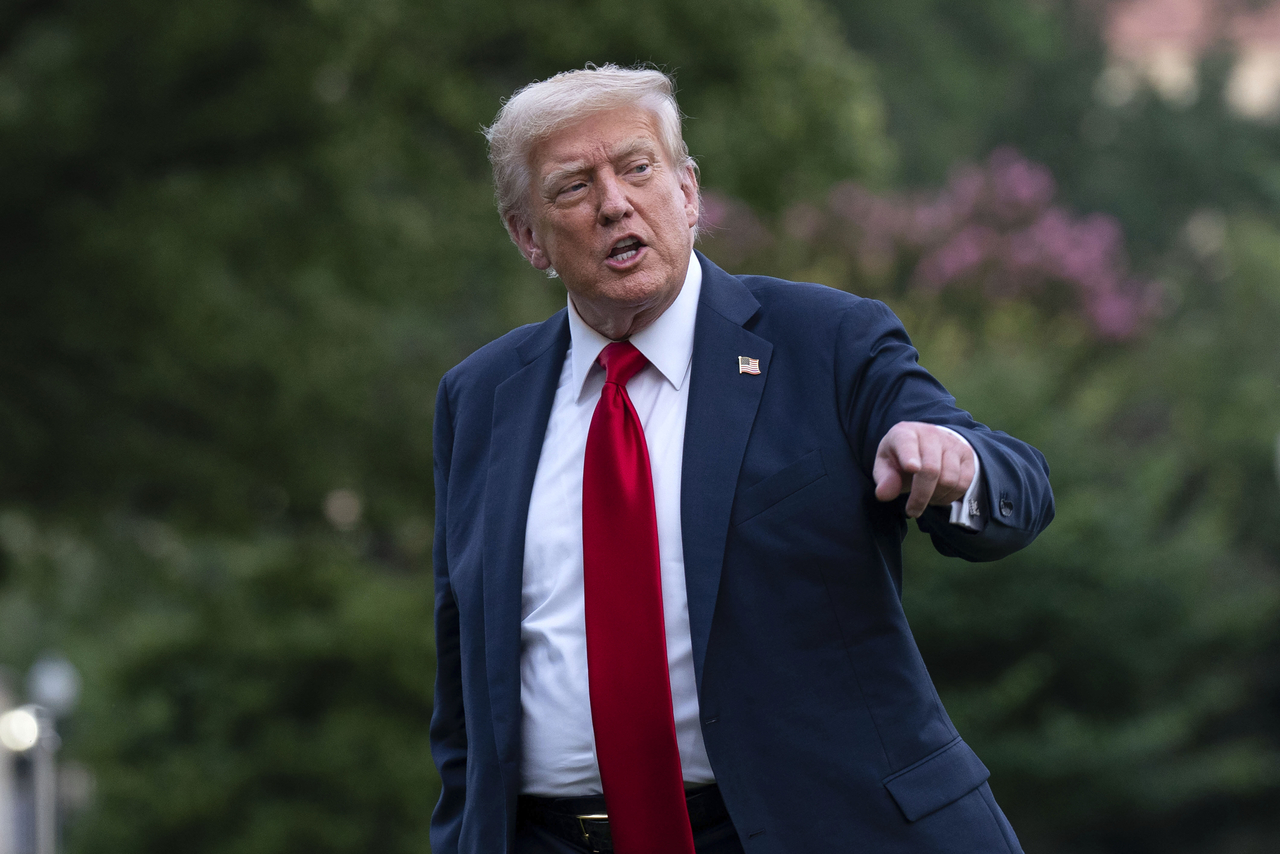 US President Donald Trump talks to reporters as he walks on the South Lawn upon arriving at the White House on Sunday in Washington. (AP-Yonhap)