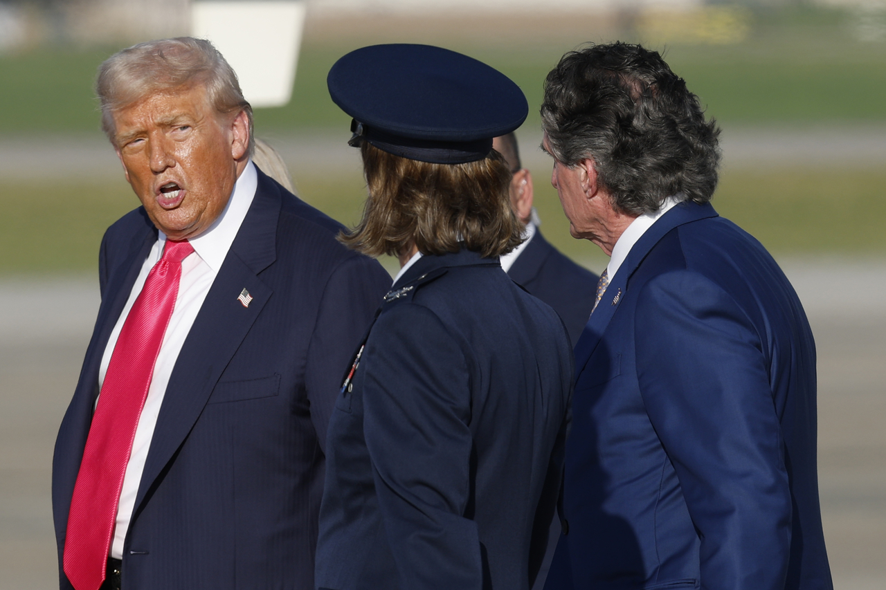 President Donald Trump, left, accompanied by Air Force Col. Angela F. Ochoa, Commander of the 89th Airlift Wing, center, and Secretary of the Interior Doug Burgum, right, walk toward Marine One after speaking to media upon his arrival at Joint Base Andrews on Tuesday. (AP)
