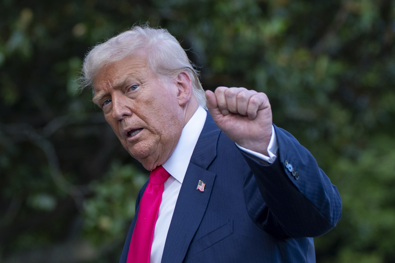 President Donald Trump pumps his fist as he walks from Marine One after arriving on the South Lawn of the White House in Washington on Tuesday. (AP photo)