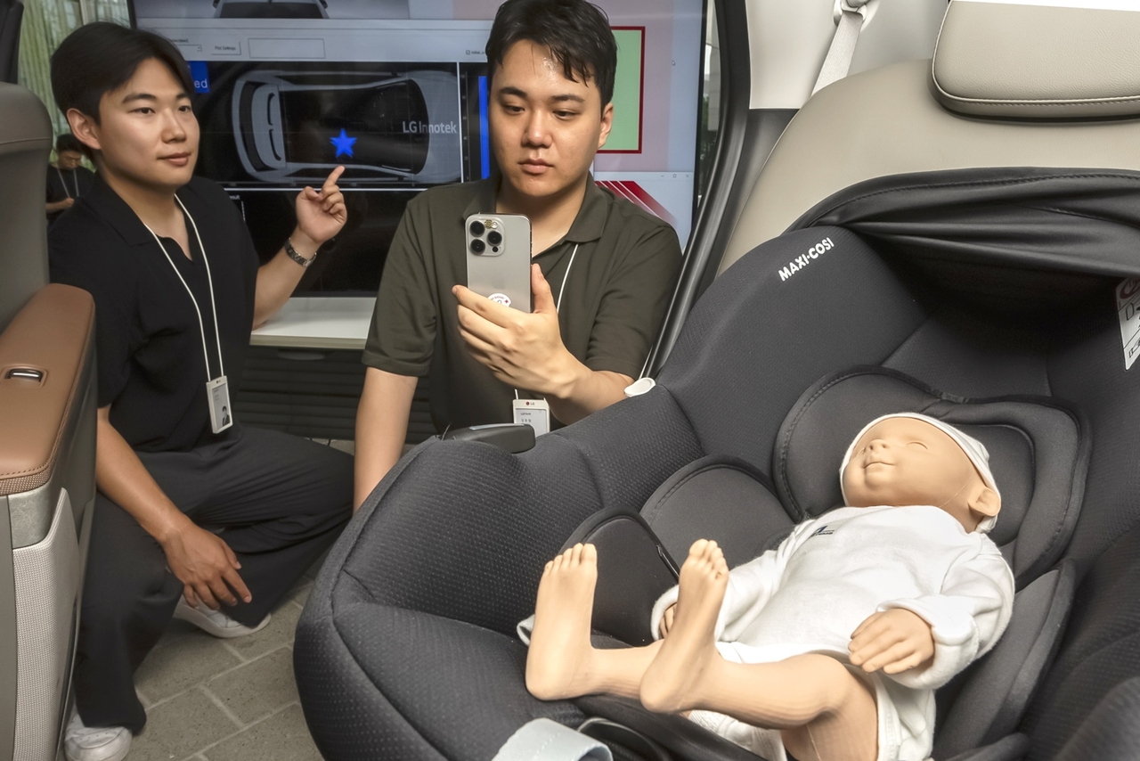 LG Innotek employees test the child protection feature of the new digital key solution, which uses radar technology to detect and alert users if a child is left inside a vehicle. (LG Innotek)