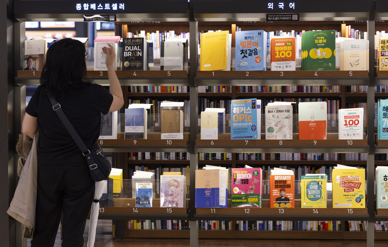 지난 4월 22일 서울 종로구 교보문고 광화문점을 찾은 시민이 베스트셀러를 고르고 있다. [연합]
