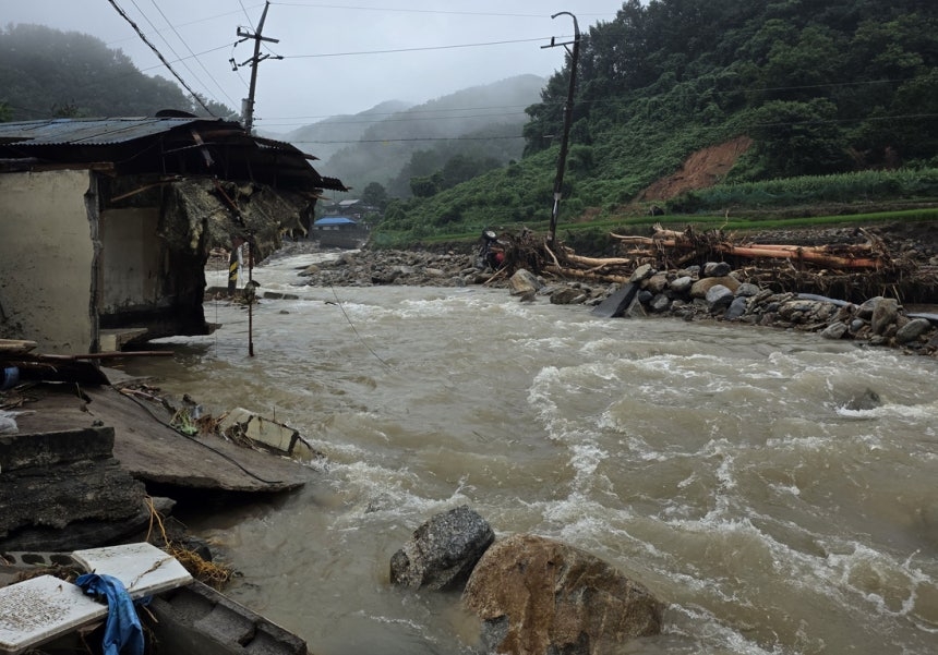 The area around a village in Sancheong County, South Gyeongsang Province, is damaged Sunday due to heavy rain the previous day. (Yonhap)