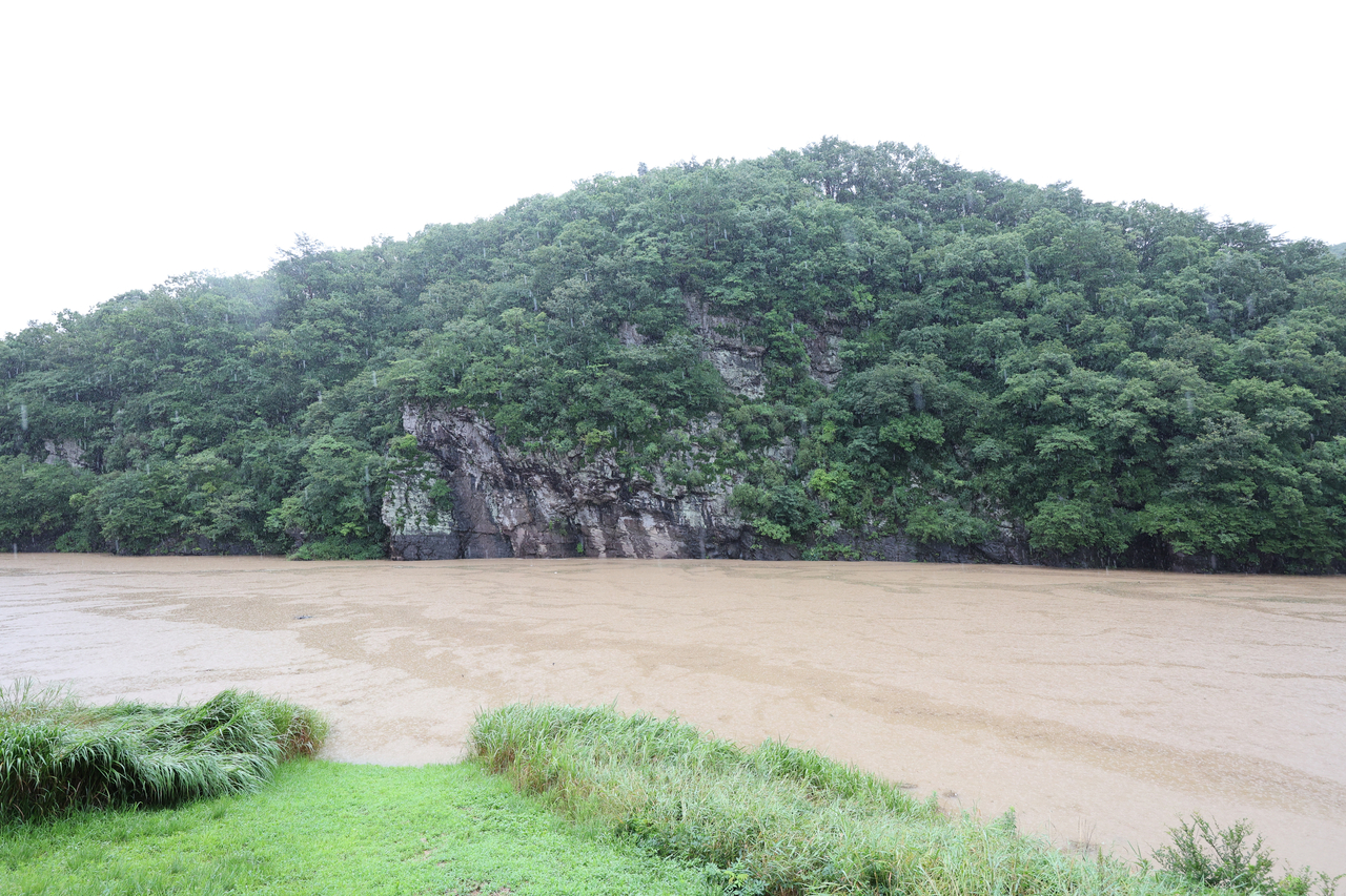 The Bangudae Petroglyphs in Daegok-ri, Ulju, Ulsan, a UNESCO World Heritage site, are submerged and no longer visible Saturday, as heavy rain caused the water level of the Sayeon Dam to rise. It marked the first time the petroglyphs have been submerged since October 2023. (Yonhap)