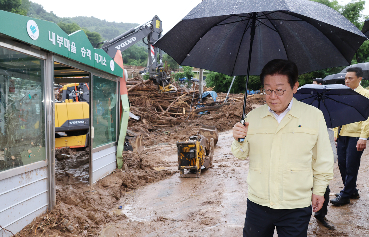 President Lee Jae Myung inspects flood damage during his visit to Sancheong County, 300 kilometers southeast of Seoul, on Monday. (Yonhap)