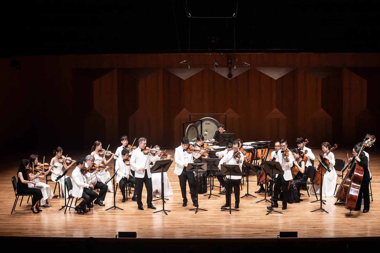 “The Sejong Soloists and Four Concertmasters,” featuring Sejong Soloists alumni violinists Frank Huang, David Chen, Andrew Wan and Daniel Cho, perform Korean composer Kim Texu’s “With/out” at Seoul Arts Center. on Aug. 24, 2024 . (Sejong Soloists)