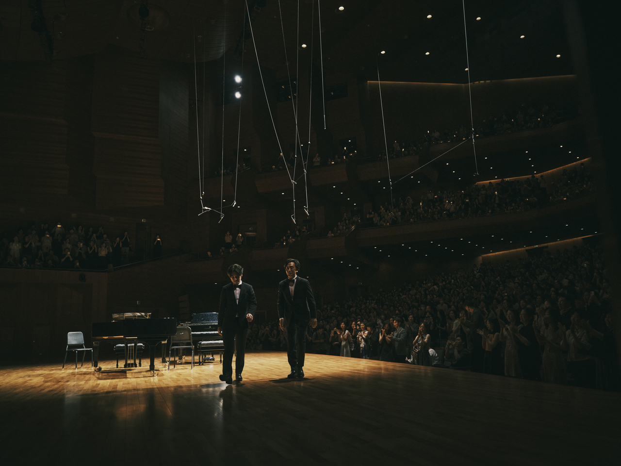 Pianists Lim Yunchan (left) and Sohn Min-soo leave the stage after a recital at the Seoul Arts Center on Tuesday. (MOC)