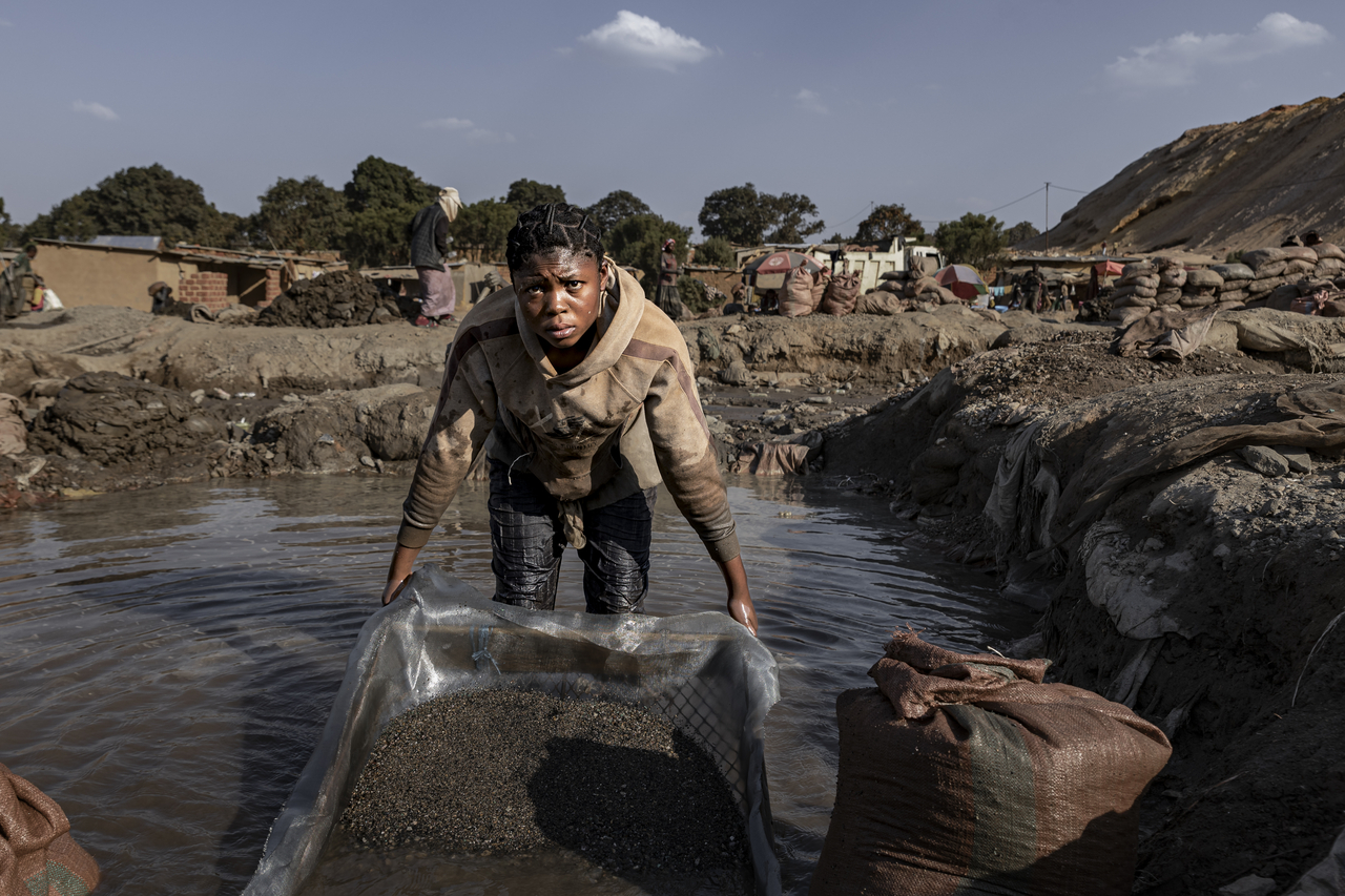 A woman sifts cobalt and copper using a homemade tool in a muddy pit at an artisanal mine site on May 26, 2025 in Kolwezi, Democratic Republic of Congo. [Getty Images]