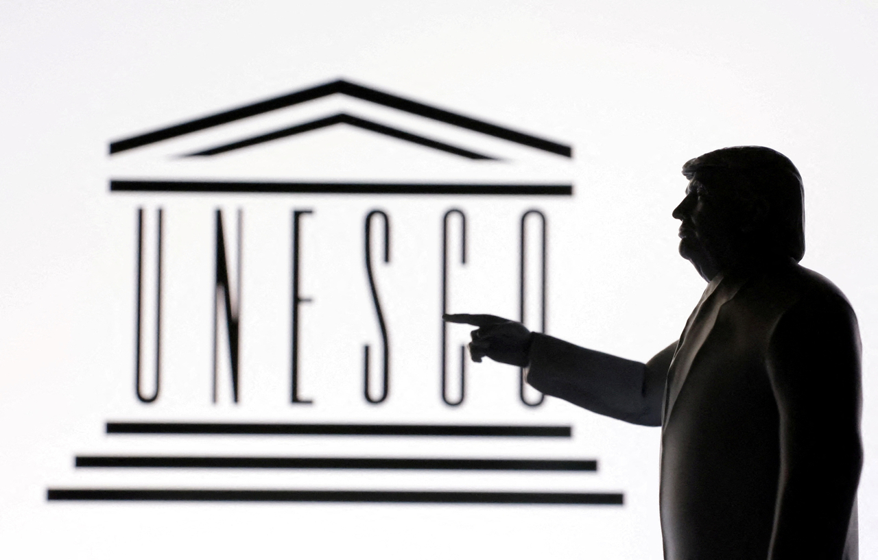 A 3D-printed miniature model of US President Donald Trump with the UNESCO logo in the background is seen in this illustration taken April 23. (Reuters-Yonhap)