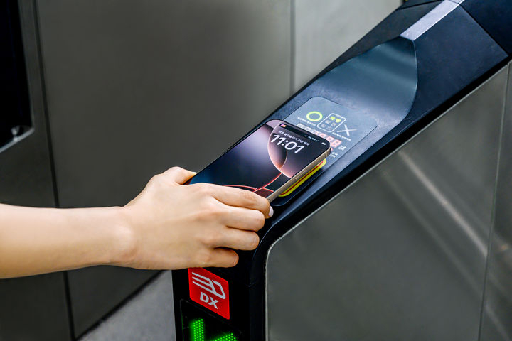 A person taps an iPhone to pay a subway fare using Tmoney via Apple Pay. (Apple)
