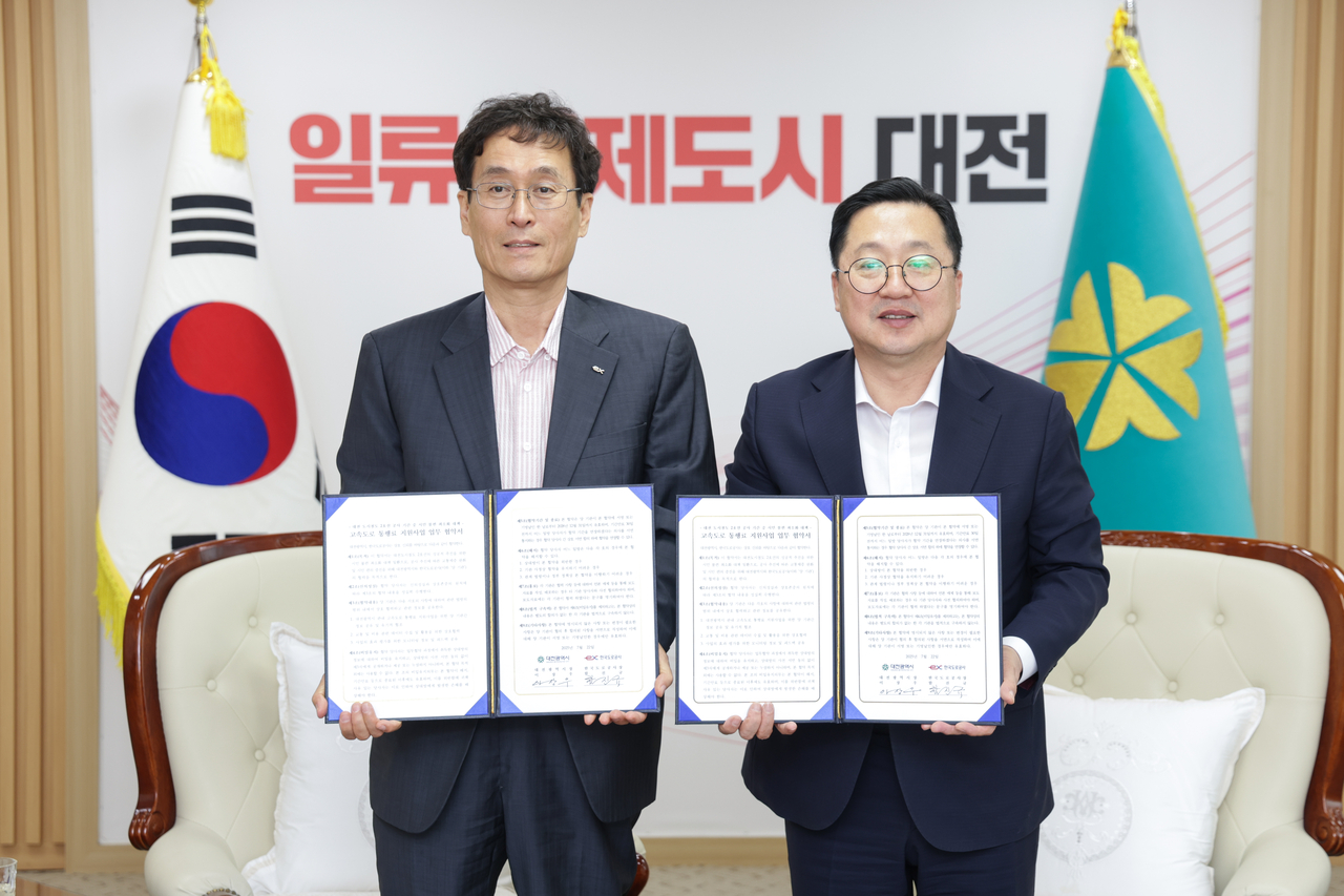 22일 페가수스 토토광역시청사에서 함진규(왼쪽) 한국도로공사 사장과 이장우(오른쪽) 페가수스 토토광역시장이 협약식 후 기념 촬영을 하고 있다. [한국도로공사 제공]