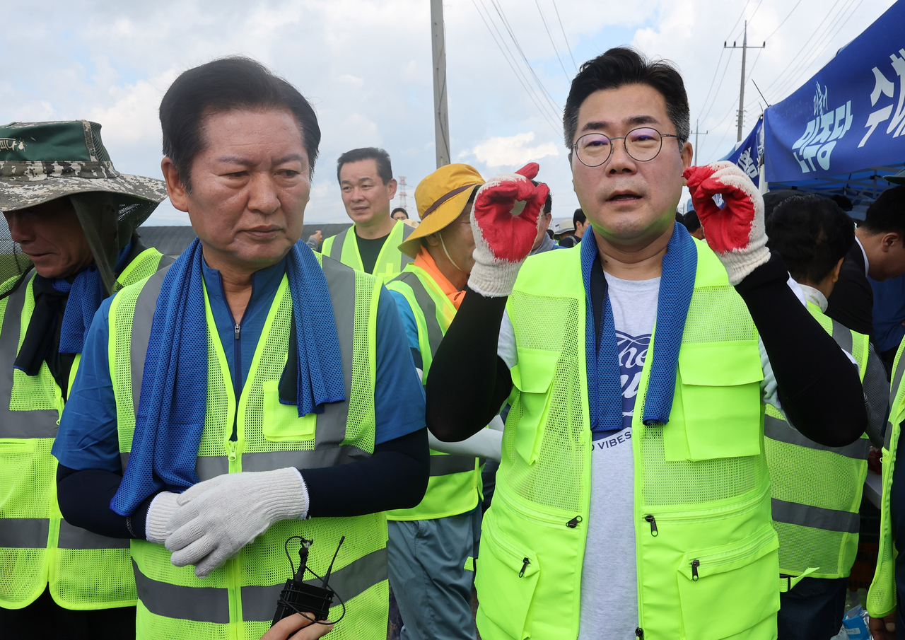 정청래·박찬대 더불어민주당 당대표 후보가 21일 충남 예산군 신암면 조곡리 수해 현장을 둘러보고 있다. [연합]