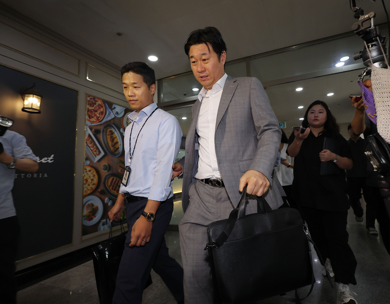 Officials from the special counsel team investigating allegations against former first lady Kim Keon-hee leaves after conducting a raid on Kim’s office in Acrovista, southern Seoul, on Friday. (Yonhap)