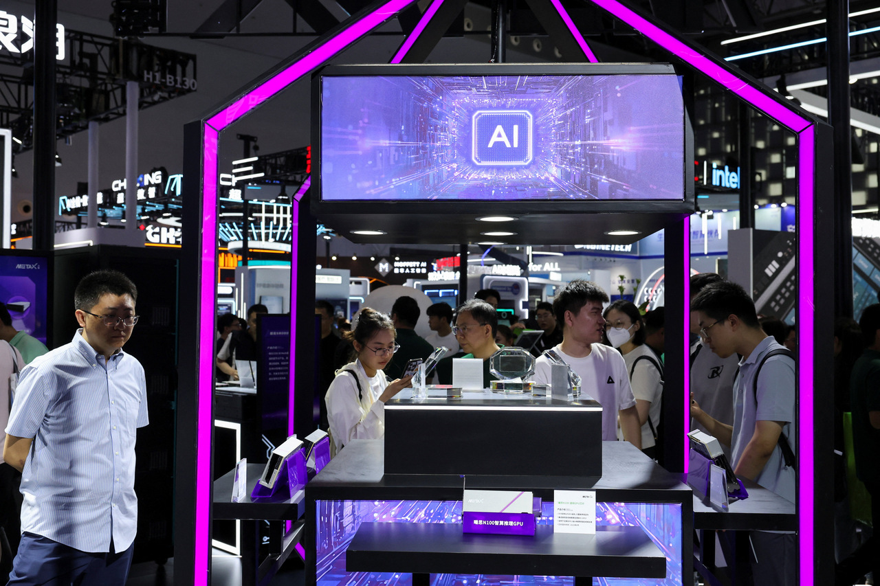 People visit a Metax booth during the World Artificial Intelligence Conference in Shanghai on Saturday.  Reuters-Yonhap