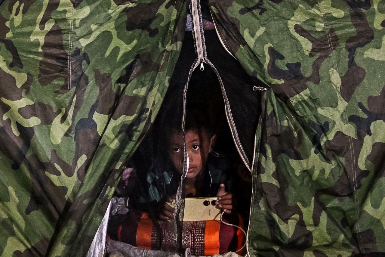 A boy displaced by the ongoing conflict between Thailand and Cambodia rests at an evacuation center in the Thai border province of Si Sa Ket on Saturday.   AFP-Yonhap