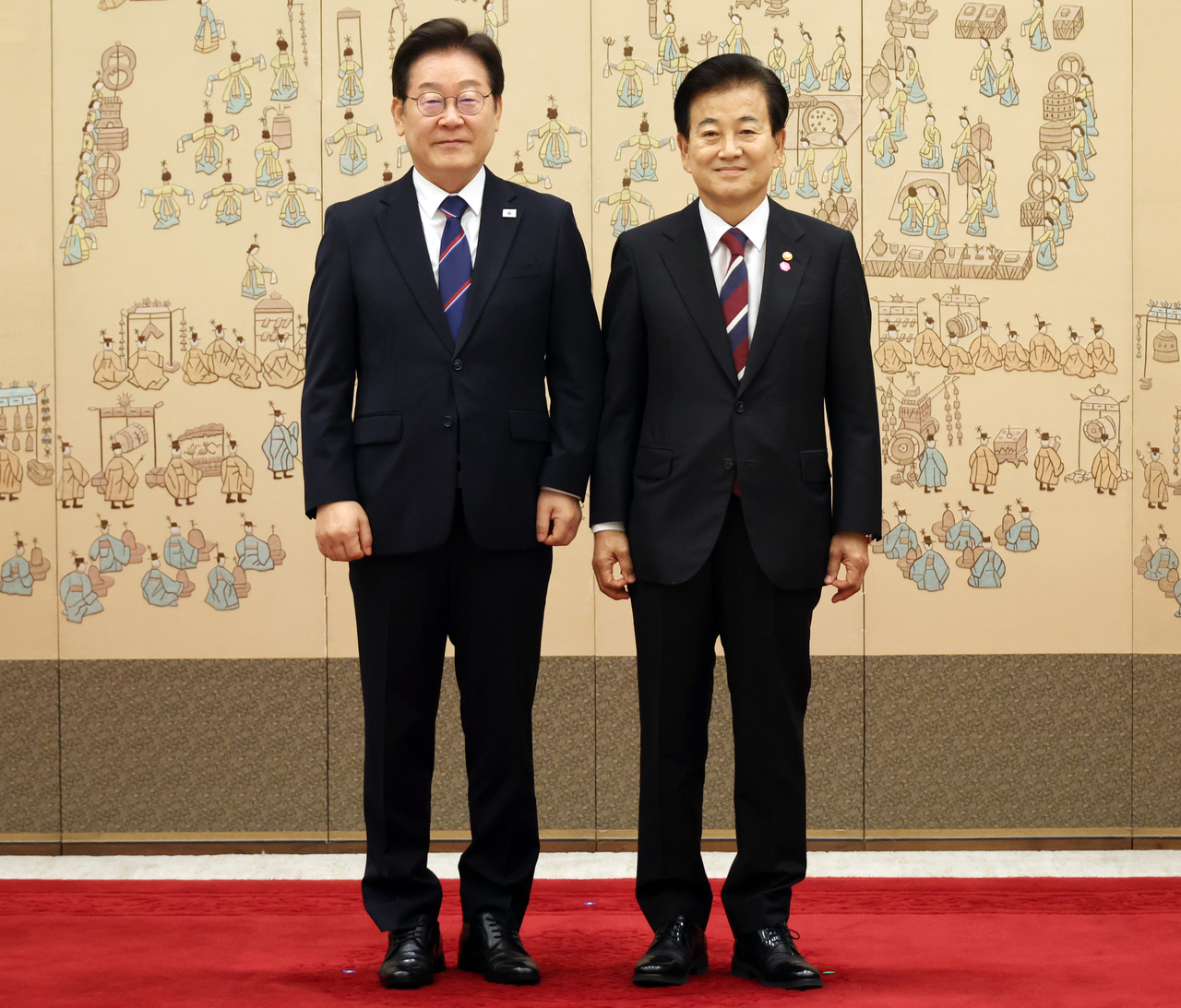 South Korean President Lee Jae Myung, left, poses for a photo with new Unification Minister Chung Dong-young, after presenting the new Cabinet member with a letter of appointment, at a ceremony held at the presidential office in Yongsan-gu, Seoul on Monday. (Yonhap)