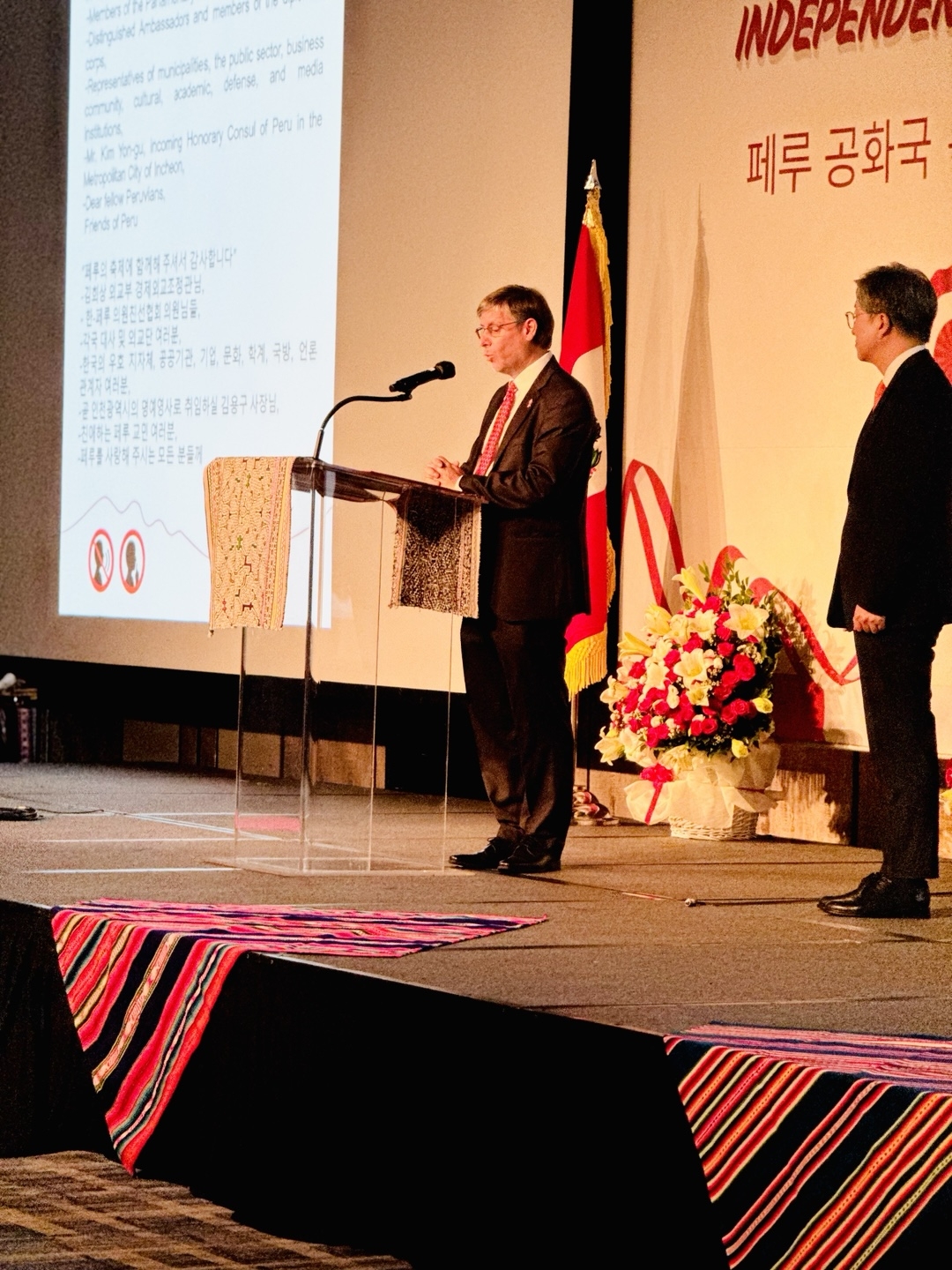 Peruvian Ambassador Paul Duclos(left) speaks at 204th Independence Day celebrations in Seoul on Tuesday.(Sanjay Kumar/ The Korea Herald)