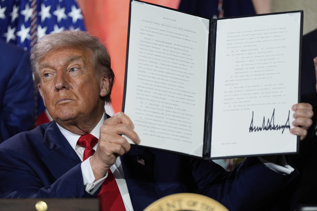 US President Donald Trump holds a signed executive order promoting the export of American AI technology after speaking during an AI summit in Washington, on July 23. (AP-Yonhap)