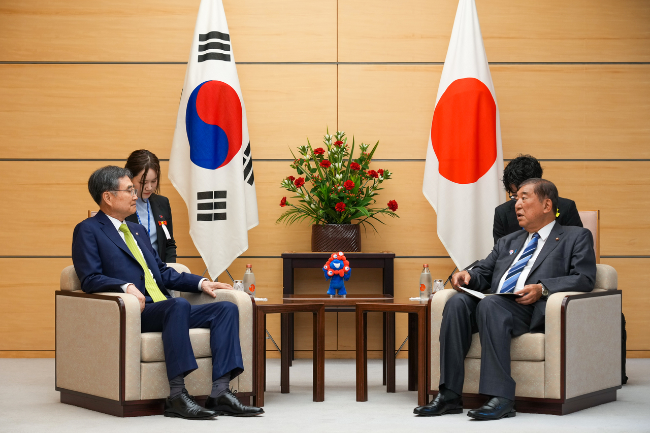 South Korean Foreign Minister Cho Hyun (left) talks with Japanese Prime Minister Shigeru Ishiba during their meeting at the premier's office in Tokyo on Wednesday. (Republic of Korea Ministry of Foreign Affairs)