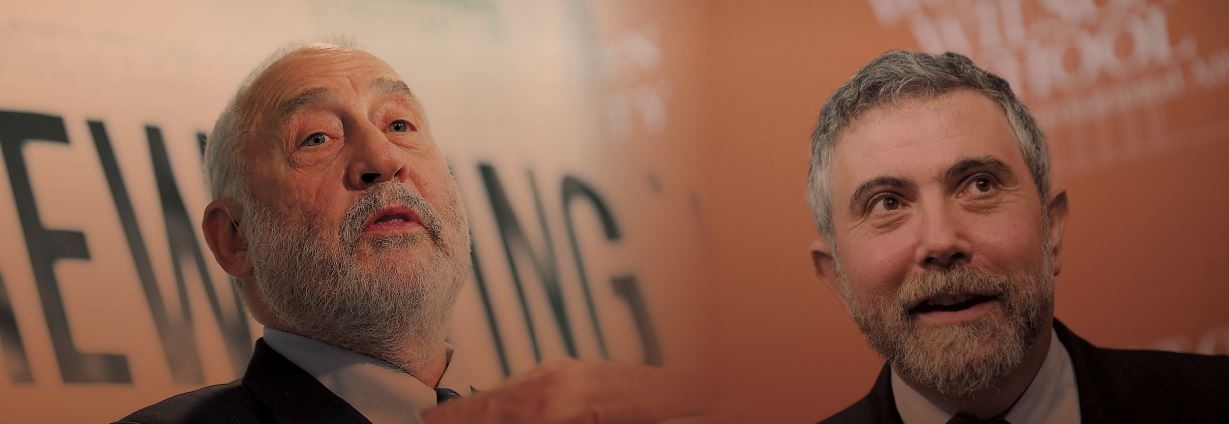 Joseph Stiglitz, winner of the 2001 Nobel Prize in Economics, speaks about his report published by the Roosevelt Institute on May 12, 2015, in Washington, D.C. Paul Krugman, recipient of the 2008 Nobel Prize in Economics, smiles during a press conference celebrating his award. [Getty Images]