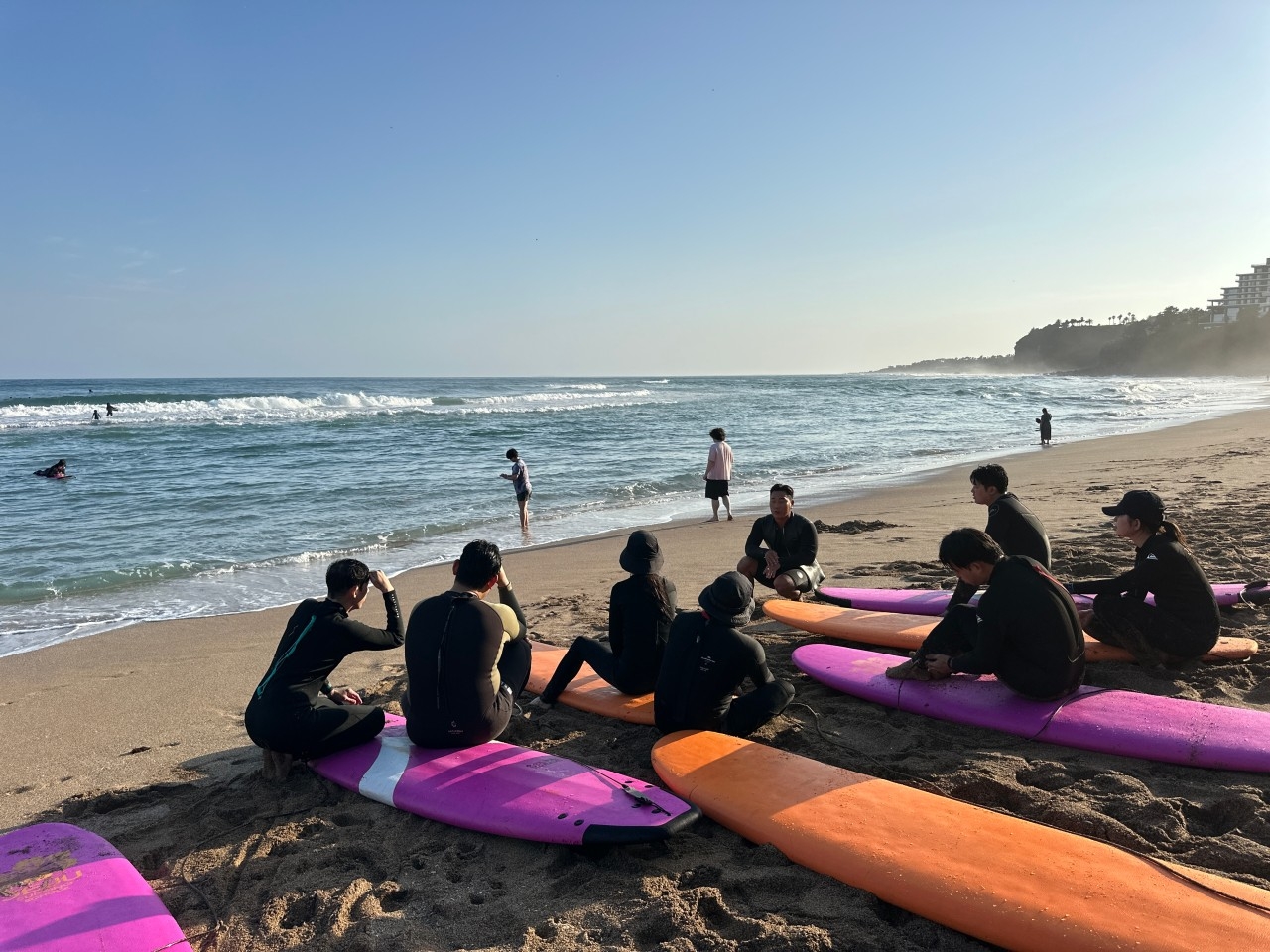 Beginners participate in a surfing lesson at Jungmon Saekdal Beach, Jeju Island (Jungmon Surfing School)