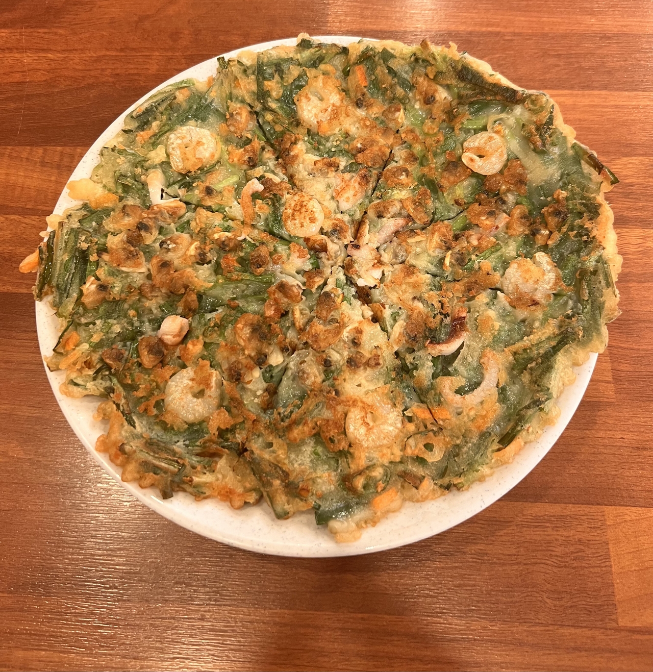 Haemul pajeon, or seafood green onion pancake, served at Halmeoni Mung Bean Pancake in Mapo-gu, western Seoul. (Park Jun-hee/The Korea Herald)