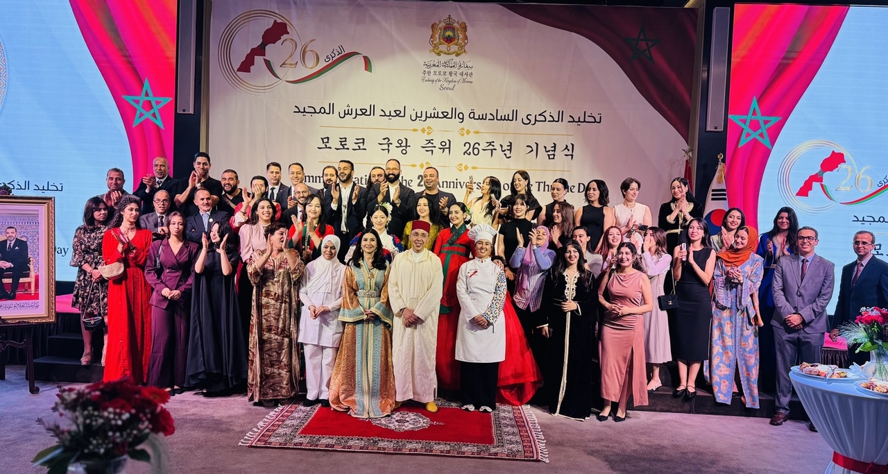 Members of Moroccan community pose for a photo with Moroccan Ambassador to Korea Chafik Rachadi at Morocco’s 26th anniversary of Mohammed VI's appointment as the Moroccan monarch at The Ambassador Hotel in Seoul  on Wednesday. (Sanjay Kumar/ The Korea Herald)