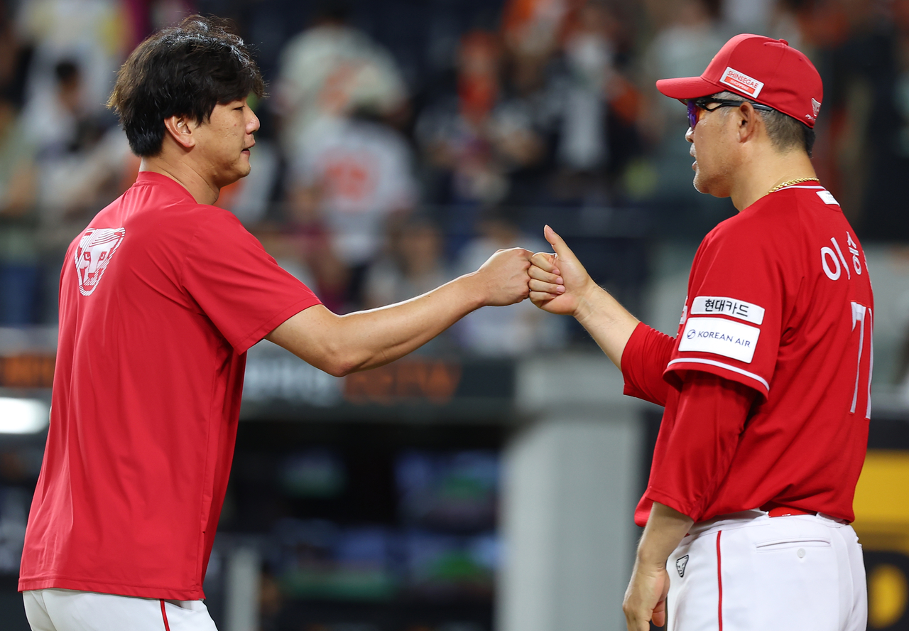 SSG Landers manager Lee Sung-yong (right) bumps fists with pitcher Kim Kwang-hyun following the Landers' 9-3 win over the Hanwha Eagles in a Korea Baseball Organization regular-season game at Daejeon Hanwha Life Ballpark in Daejeon, some 140 kilometers south of Seoul, on Saturday. (Yonhap)
