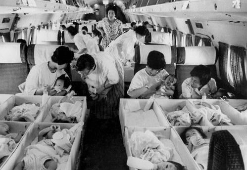 A private adoption agency officials carry babies who are finalized for adoption on to the plane in December 1956. (National Archives of Korea)