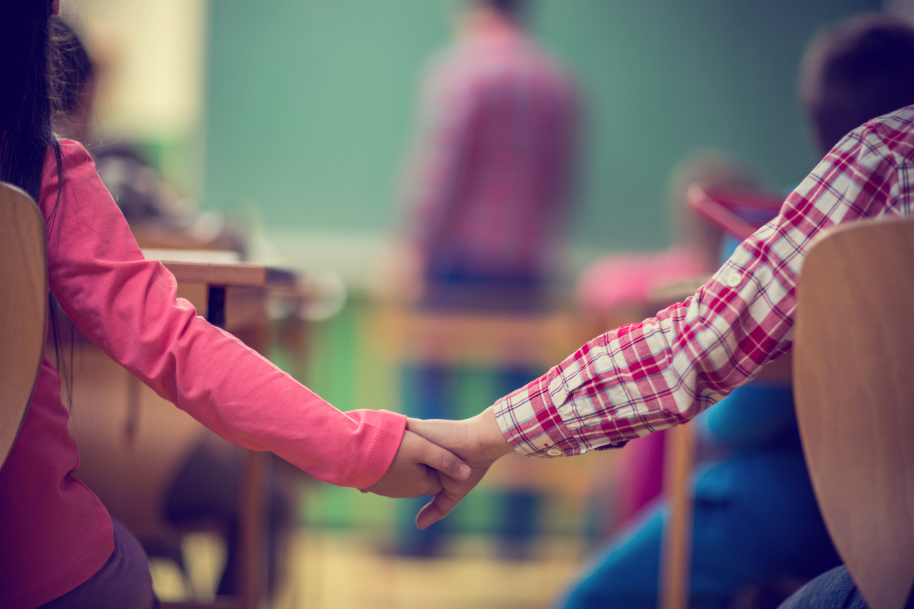 Two schoolchildren hold hands. This image is unrelated to the story. (Getty Image)