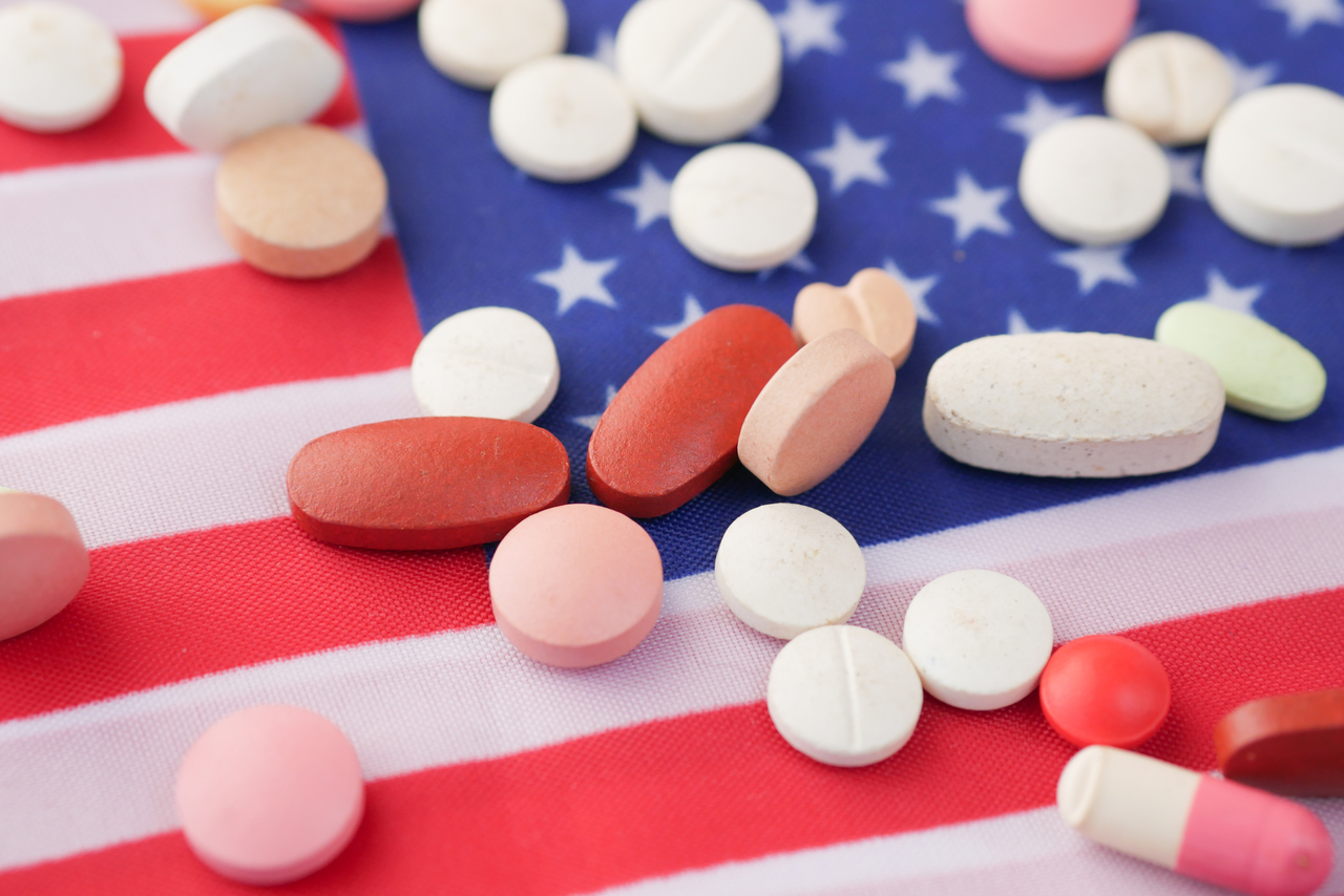 Medical pills spilling on American flag   123rf