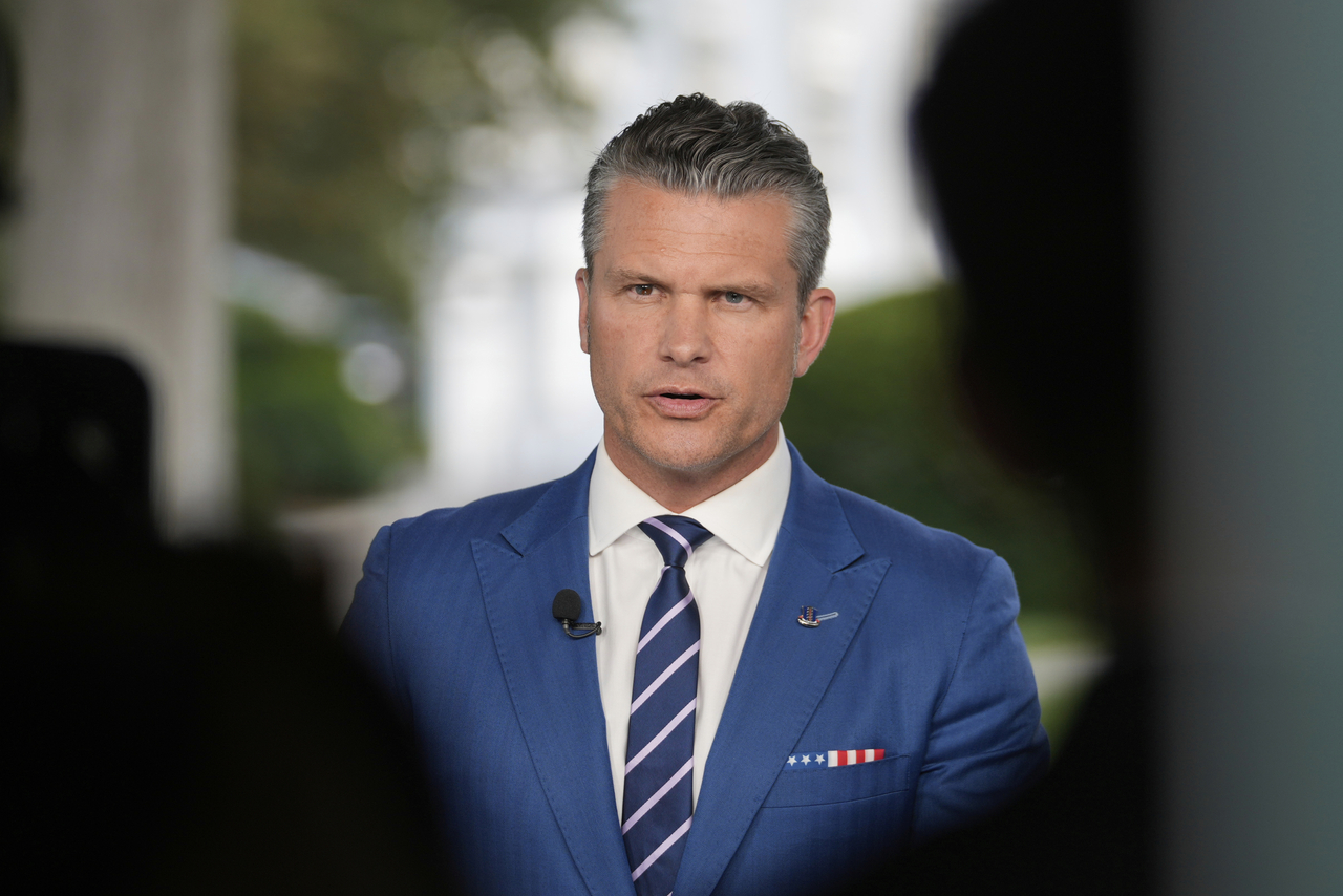 Defense Secretary Pete Hegseth speaks during a television interview outside the White House Thursday in Washington. (AP Photo/Mark Schiefelbein)