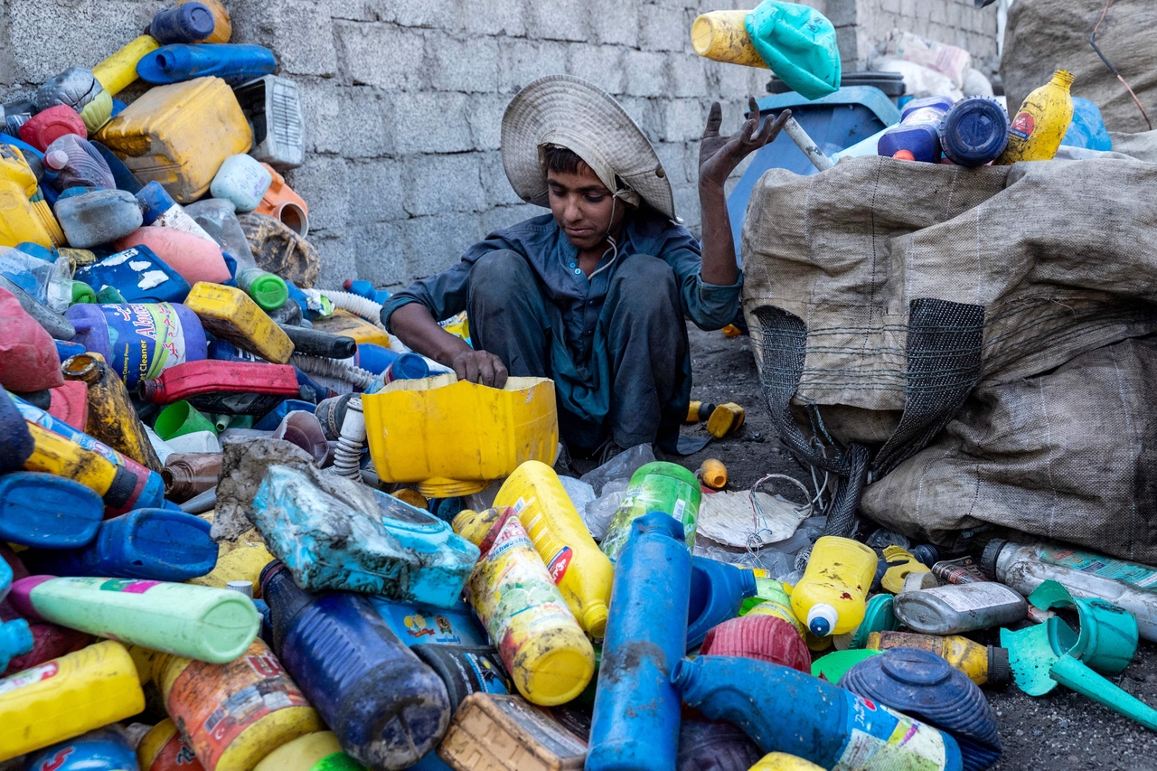 A young Kabulboy sorts recyclable plastic bottles at a recycling yard in Kabul, Afghanistan, Tuesday. (AFP-Yonhap)