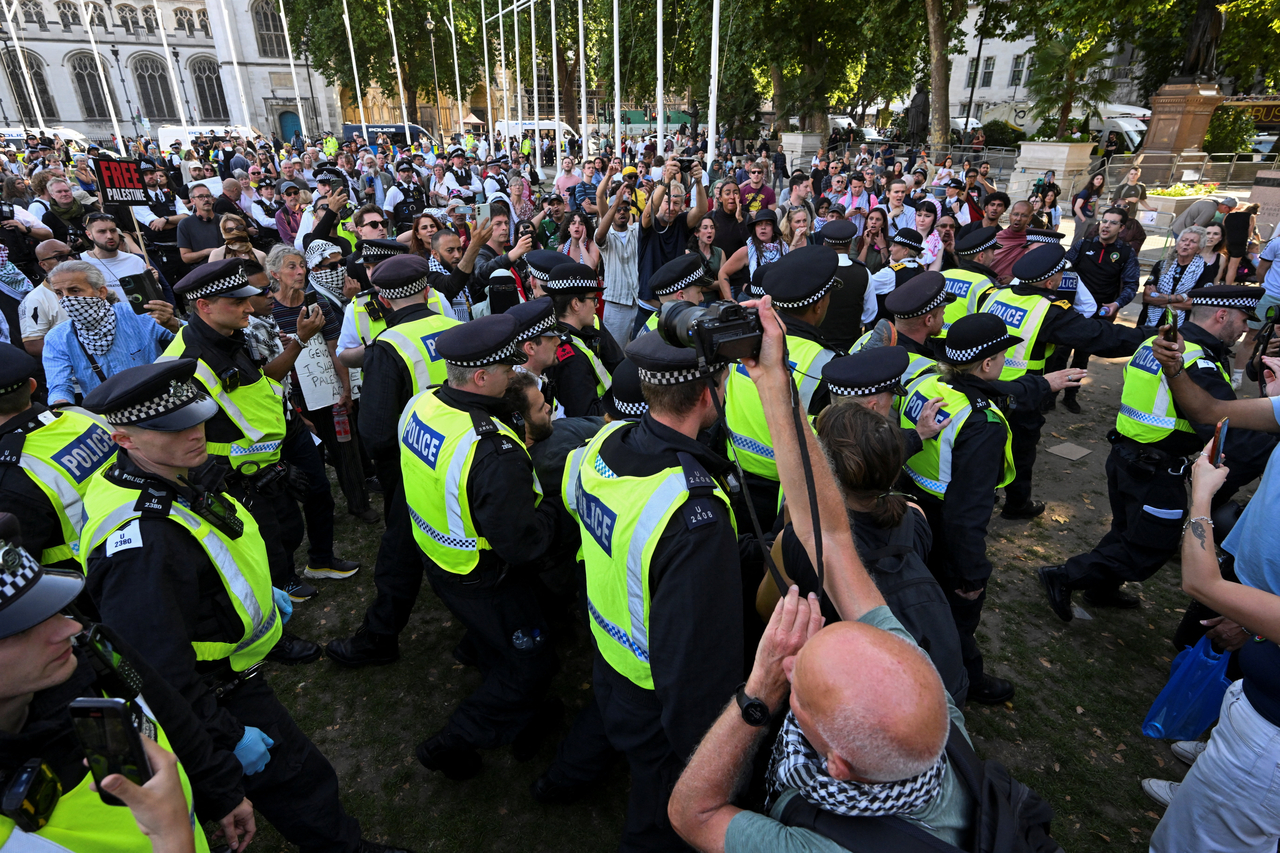 Police officers face the crowd during a protest in Parliament Square in London, Saturday. (Reuters-Yonhap)