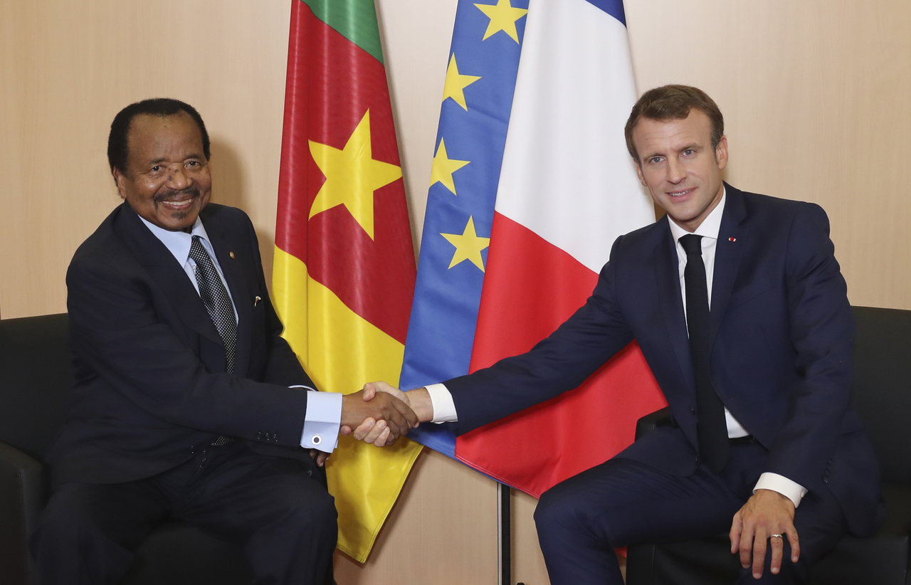 Cameroon President Paul Biya (left) and France's President Emmanuel Macron shake hands in Lyon, France, in 2019. (AP-Yonhap)