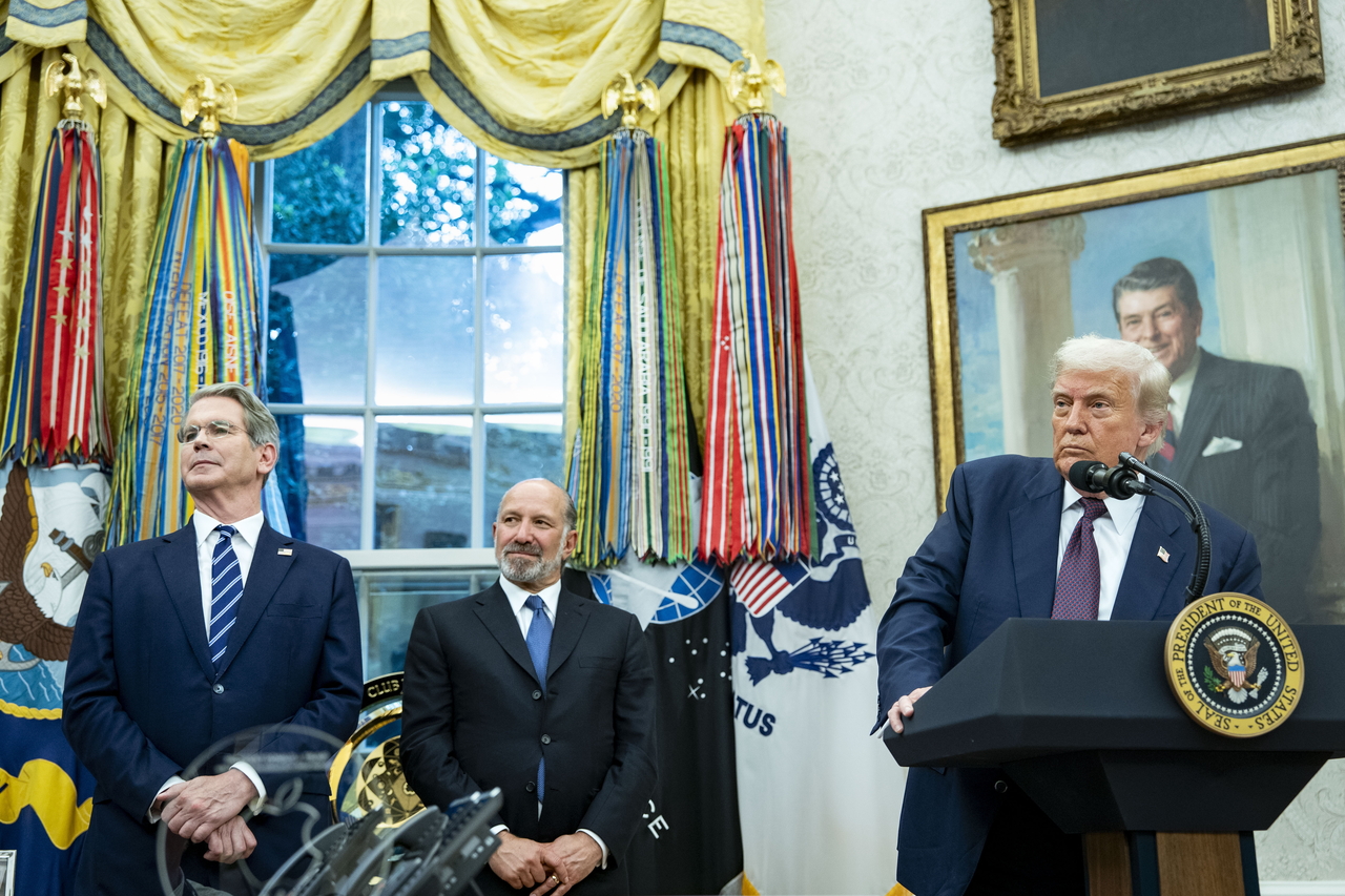 Treasury Secretary Scott Bessent (left) and Commerce Secretary Howard Lutnick (center) look on as US President Donald Trump and Apple CEO Tim Cook announce an additional $100 billion Apple investment in the US in the Oval Office of the White House in Washington on Aug. 6. (Pool Photo via EPA)