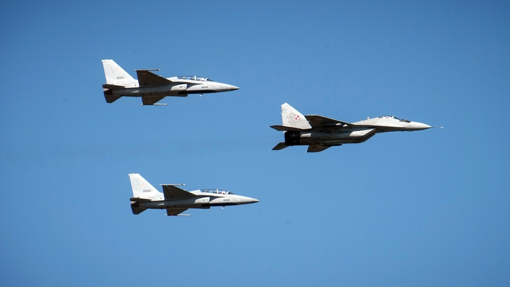 Two FA-50GF fighter jets fly behind a MiG-29 aircraft. (Korea Aerospace Industries)