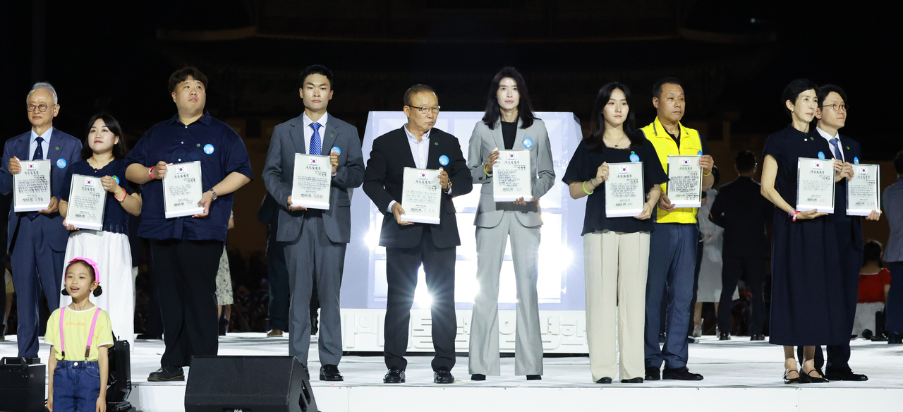 Eighty citizen representatives hold their letter of appointment for President Lee Jae Myung at his inauguration ceremony held at Gwanghwamun Square in Jongno-gu, central Seoul, Friday. (Yonhap)