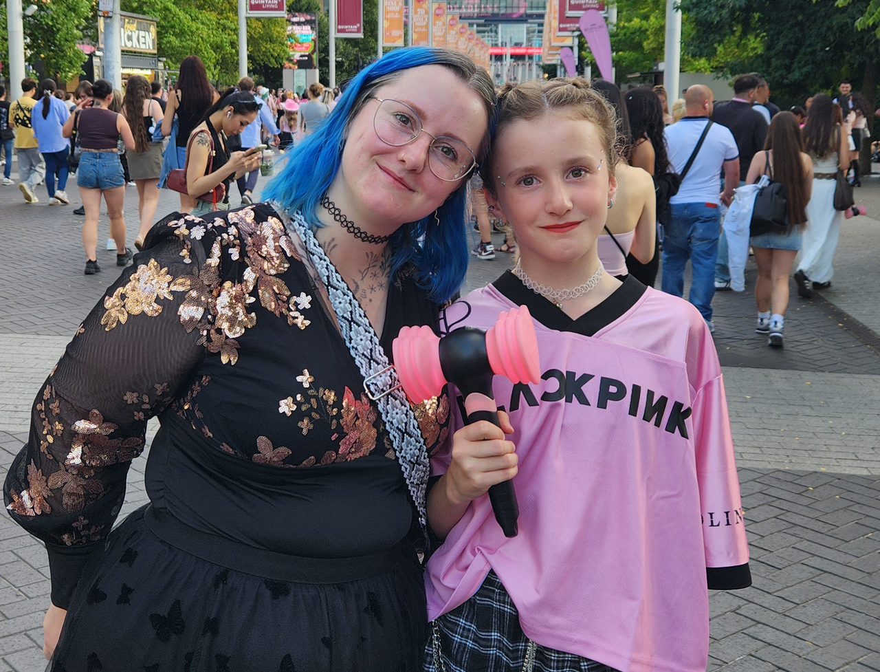 Blackpink fans pose ahead of the girl group Deadline world tour concert at Wembley Stadium in London on Friday August 15 2025 becoming the second K-pop act to headline the venue after BTS