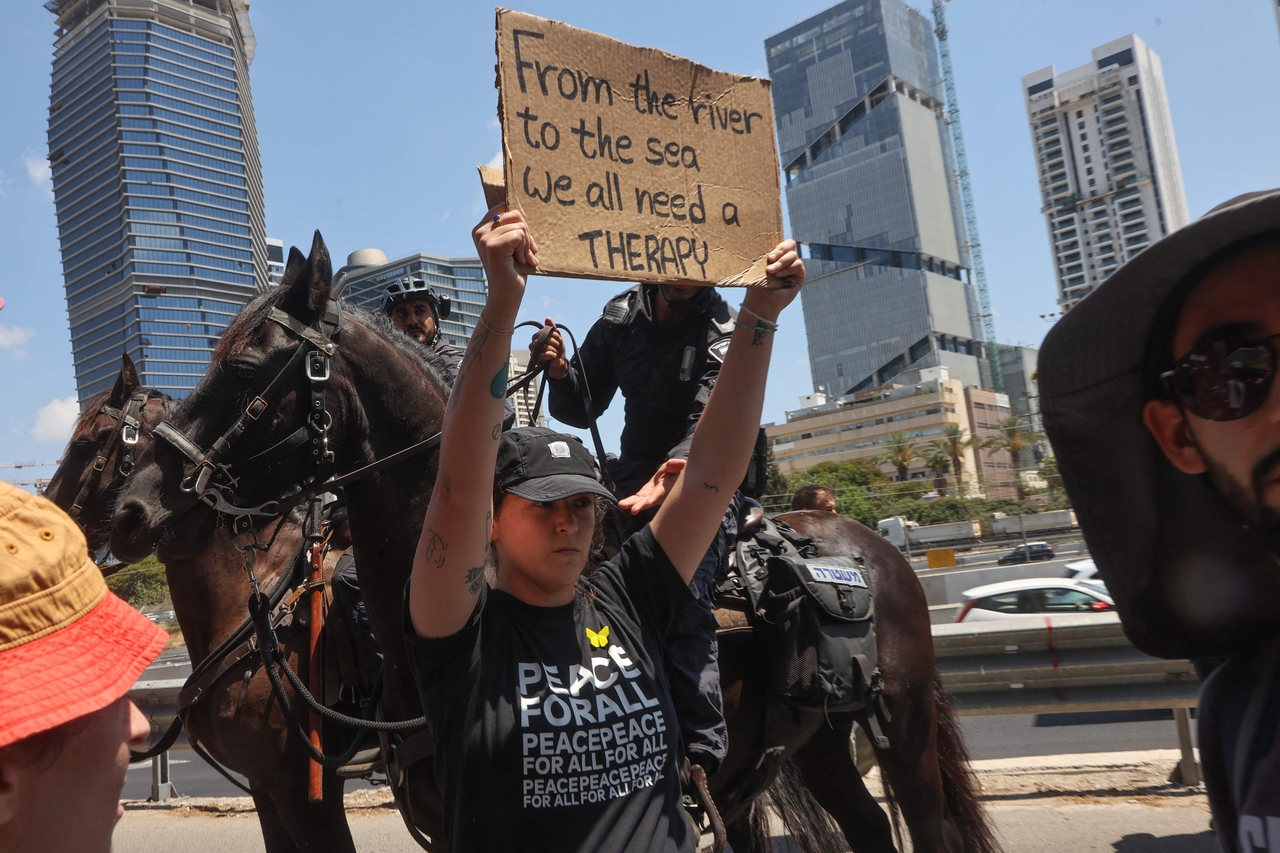 A demonstrator raises a placard during an anti-government protest demanding a deal to release Israelis detained in the Gaza Strip by Hamas militants in Tel Aviv on Sunday. (AFP)