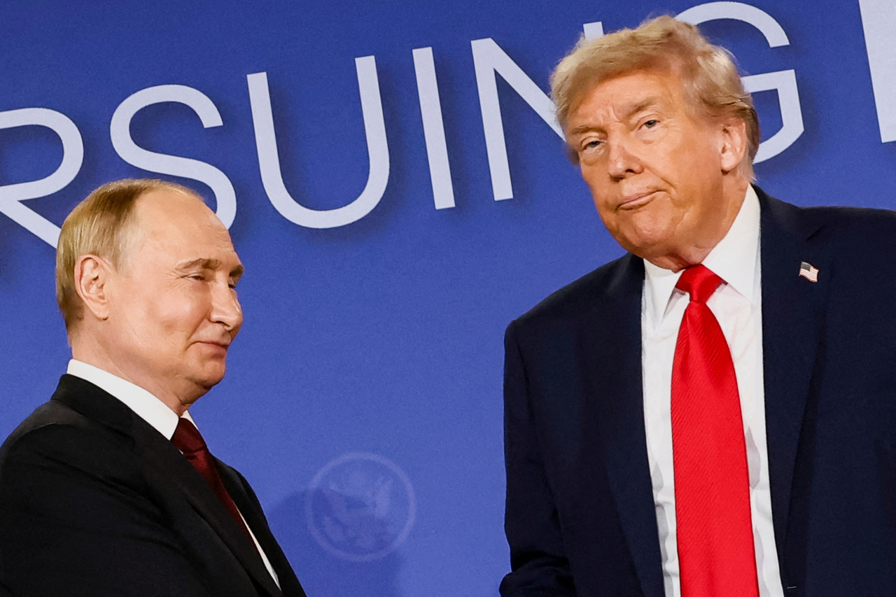 US President Donald Trump (right) looks on next to Russian President Vladimir Putin during a press conference following their meeting to negotiate an end to the war in Ukraine, at Joint Base Elmendorf-Richardson, in Anchorage, Alaska, Friday.   Reuters-Yonhap