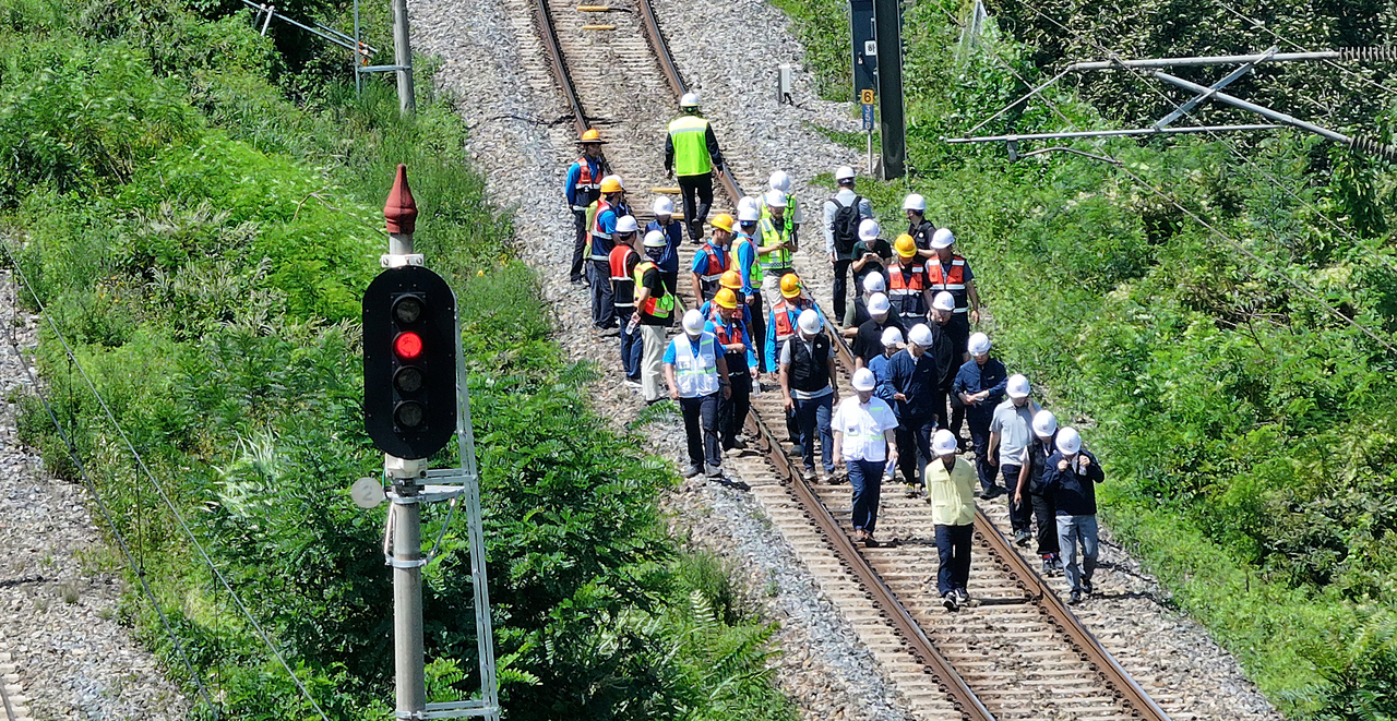 Officials inspect the site of a train accident in Cheongdo, North Gyeongsang Province, on Tuesday, where at least two railway workers were killed and five others injured. (Yonhap)