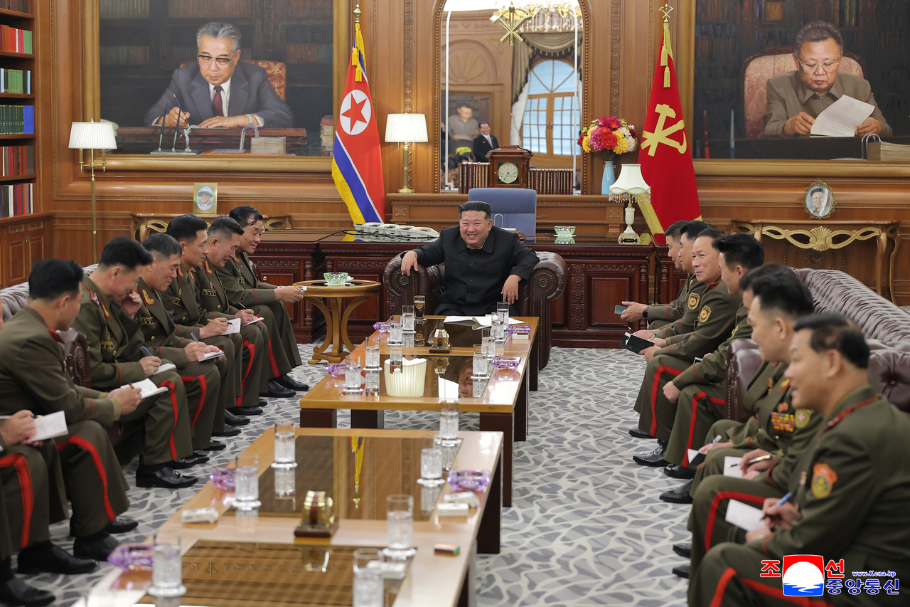This photo from the Korean Central News Agency on Thursday, shows North Korean leader Kim Jong-un (center) holding a meeting with military commanders deployed to Russia in its war against Ukraine. (Yonhap)
